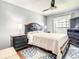 Comfortable bedroom with ceiling fan, two side tables, a large bed, and a stylish rug at 500 Newell Hill Rd # 113D, Leesburg, FL 34748