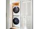 Efficiently stacked washer and dryer units neatly tucked behind louvered doors at 500 Newell Hill Rd # 113D, Leesburg, FL 34748
