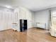 Bright living room featuring hardwood floors, modern decor, and ample closet space at 500 Newell Hill Rd # 113D, Leesburg, FL 34748