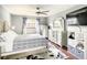 Well-lit bedroom with ceiling fan, dresser, and a plush bed with blue patterned linens at 500 Newell Hill Rd # 113D, Leesburg, FL 34748