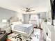 Comfortable main bedroom featuring a padded headboard, ceiling fan, and decorative dresser with mirror at 500 Newell Hill Rd # 113D, Leesburg, FL 34748