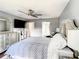 Bright main bedroom features a ceiling fan, TV, and decorative dressers for ample storage at 500 Newell Hill Rd # 113D, Leesburg, FL 34748