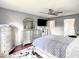 Comfortable bedroom with a TV, ceiling fan, and elegant dressers with unique mirror designs at 500 Newell Hill Rd # 113D, Leesburg, FL 34748