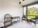 Cozy screened porch with textured walls and tile flooring, perfect for relaxation at 500 Newell Hill Rd # 113D, Leesburg, FL 34748