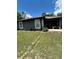 Backyard with a screened porch with concrete flooring, plants, and patio furniture at 5051 Nw 61St Ct, Ocala, FL 34482