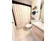 Bathroom featuring shower with curtain, white toilet, and tiled floors at 5051 Nw 61St Ct, Ocala, FL 34482