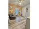 Bedroom with wood flooring, wood accent wall, sofa, and double closets at 5051 Nw 61St Ct, Ocala, FL 34482