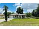 Inviting single-story home with a manicured lawn, showcasing its curb appeal at 5051 Nw 61St Ct, Ocala, FL 34482