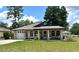 Charming single-story home with well-manicured lawn and inviting front porch at 5051 Nw 61St Ct, Ocala, FL 34482