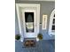 Charming front door entrance with a welcome mat and decorative plants at 5051 Nw 61St Ct, Ocala, FL 34482