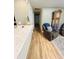 Hallway featuring hardwood floors, leading to the living area at 5051 Nw 61St Ct, Ocala, FL 34482