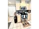Kitchen with stainless steel oven, tile backsplash, and wooden cabinetry at 5051 Nw 61St Ct, Ocala, FL 34482