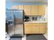Spacious kitchen with stainless steel refrigerator, wooden cabinetry and marble countertops at 5051 Nw 61St Ct, Ocala, FL 34482