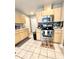 Kitchen with stainless steel oven, tile backsplash, and wooden cabinetry at 5051 Nw 61St Ct, Ocala, FL 34482