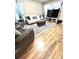 Bright living room featuring hardwood floors, comfortable seating, and modern decor at 5051 Nw 61St Ct, Ocala, FL 34482