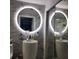 Modern bathroom with a stylish vessel sink, illuminated round mirror, and sleek marble-patterned walls at 508 Villa Del Sol Cir # 105, Orlando, FL 32824