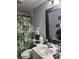 A compact bathroom features a white vanity, patterned shower curtain, and decorative accents at 508 Villa Del Sol Cir # 105, Orlando, FL 32824