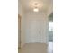 Bright foyer features neutral tile flooring and a classic pendant light fixture at 520 Silver Palm Dr, Haines City, FL 33844