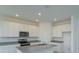 Modern kitchen with white cabinets, granite countertops, and stainless steel appliances at 520 Silver Palm Dr, Haines City, FL 33844