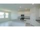 Open kitchen featuring white cabinets, granite counters, stainless appliances, and island with sink at 520 Silver Palm Dr, Haines City, FL 33844