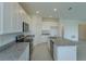 Well-lit kitchen with granite countertops, stainless steel appliances, and ample counter space at 520 Silver Palm Dr, Haines City, FL 33844