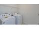 This home features a functional laundry area with washer and dryer hookups and storage shelving at 520 Silver Palm Dr, Haines City, FL 33844