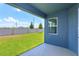 A covered patio offers views of the green backyard and privacy fencing at 520 Silver Palm Dr, Haines City, FL 33844