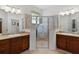 Elegant bathroom with double vanities, a glass-enclosed shower, and stylish fixtures at 541 Cokesbury Dr, The Villages, FL 32162