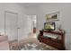 Well-lit bedroom features carpeted flooring, closet, and TV at 541 Cokesbury Dr, The Villages, FL 32162