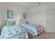 Well-lit bedroom features two twin beds, carpet flooring, closet, and ceiling fan at 541 Cokesbury Dr, The Villages, FL 32162