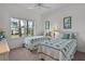 Bright bedroom with two twin beds, large window, neutral carpet, and ceiling fan at 541 Cokesbury Dr, The Villages, FL 32162