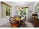 Cozy dining room featuring a wood table and chairs, complemented by a decorative chandelier and natural light at 541 Cokesbury Dr, The Villages, FL 32162
