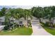 Charming single-story home with a well-manicured lawn and lush landscaping with palm trees at 541 Cokesbury Dr, The Villages, FL 32162