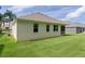 Back of house shows the nice yard and the screened-in porch at 541 Cokesbury Dr, The Villages, FL 32162
