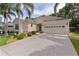 Charming home with a well-manicured lawn, mature landscaping, and a spacious driveway leading to the two-car garage at 541 Cokesbury Dr, The Villages, FL 32162