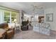 Open living space with a partial view of the kitchen, featuring comfortable seating and plenty of natural light at 541 Cokesbury Dr, The Villages, FL 32162