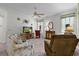 Inviting living room with plush seating, a ceiling fan, and abundant natural light from large windows at 541 Cokesbury Dr, The Villages, FL 32162