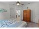 Bedroom featuring neutral walls and carpet, complemented by a ceiling fan and ample closet space at 541 Cokesbury Dr, The Villages, FL 32162