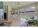 Cozy sunroom with tiled floors, comfortable furniture, and expansive windows offering serene outdoor views at 541 Cokesbury Dr, The Villages, FL 32162