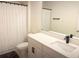 Bright bathroom featuring a modern vanity with white countertop and sleek black faucet at 591 Black Eagle Dr, Groveland, FL 34736