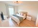 Bright bedroom featuring a comfortable queen-sized bed, neutral decor, and ample natural light from the window at 591 Black Eagle Dr, Groveland, FL 34736