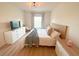 Bright bedroom with wood floors, neutral walls, and a decorative ceiling light fixture at 591 Black Eagle Dr, Groveland, FL 34736