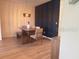 Dining area with wood floors, a modern light fixture, and a black accent wall at 591 Black Eagle Dr, Groveland, FL 34736