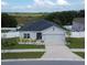 Charming single-story home featuring a well-manicured lawn, a two-car garage, and beautiful landscaping in a suburban setting at 591 Black Eagle Dr, Groveland, FL 34736