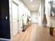 Bright, airy hallway with light wood floors and stylish modern decor at 591 Black Eagle Dr, Groveland, FL 34736