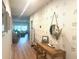 Bright hallway featuring modern decor, wood-look floors, and a view into the living area at 591 Black Eagle Dr, Groveland, FL 34736
