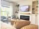 Cozy living room with a modern fireplace, built-in shelving, and comfortable seating at 591 Black Eagle Dr, Groveland, FL 34736