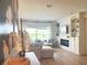 Inviting living room with built-in shelves, a modern fireplace, and large windows offering natural light at 591 Black Eagle Dr, Groveland, FL 34736