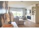 Bright living room with a cozy sectional sofa, a modern fireplace, and built-in shelving for a relaxing atmosphere at 591 Black Eagle Dr, Groveland, FL 34736