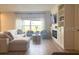 Spacious living room with a large window, comfortable seating, and modern decor at 591 Black Eagle Dr, Groveland, FL 34736
